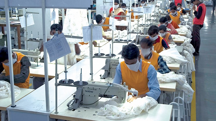 Modern garment production facility with workers at stations